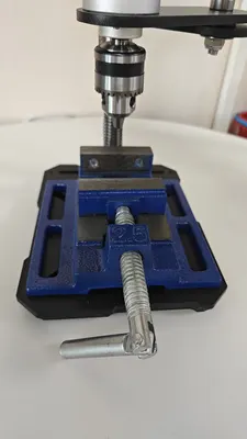 V2 vise bolted under a drill station, jaws open beneath the chuck